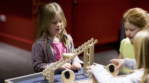 Children playing with interactive toys in Toys Through Time Gallery at The Children's Country House at Sudbury